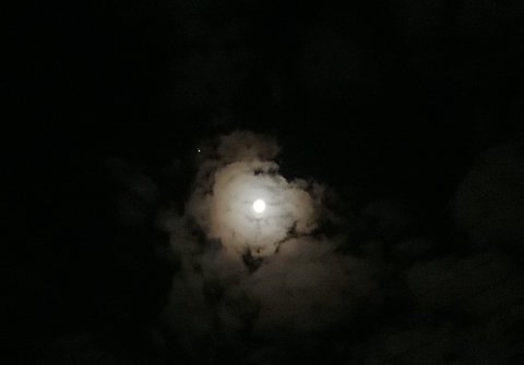 月の周りで雲が微笑んでいるのがわかります